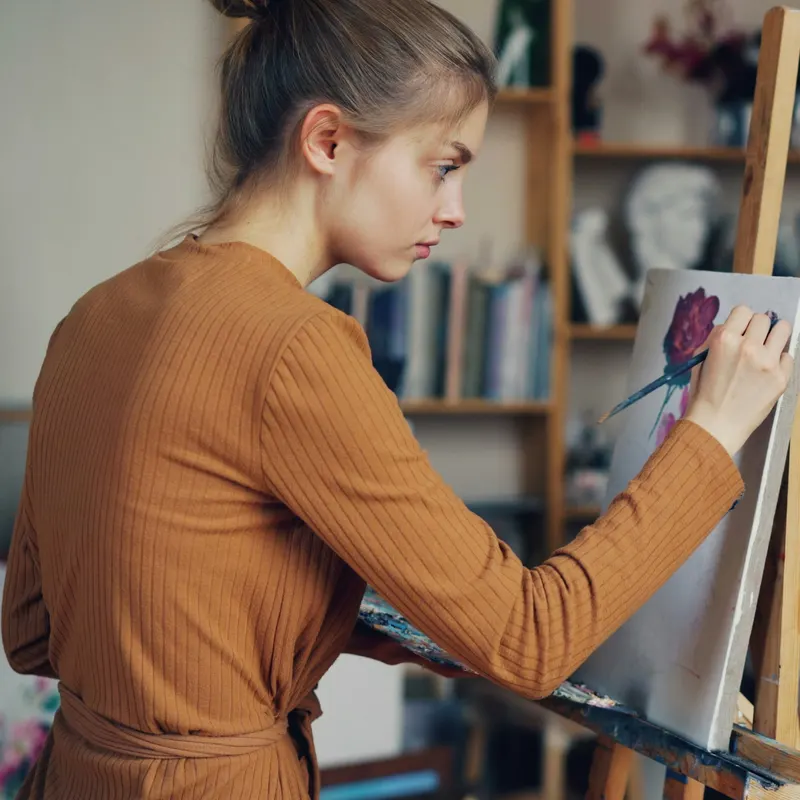 A painter working at her easel